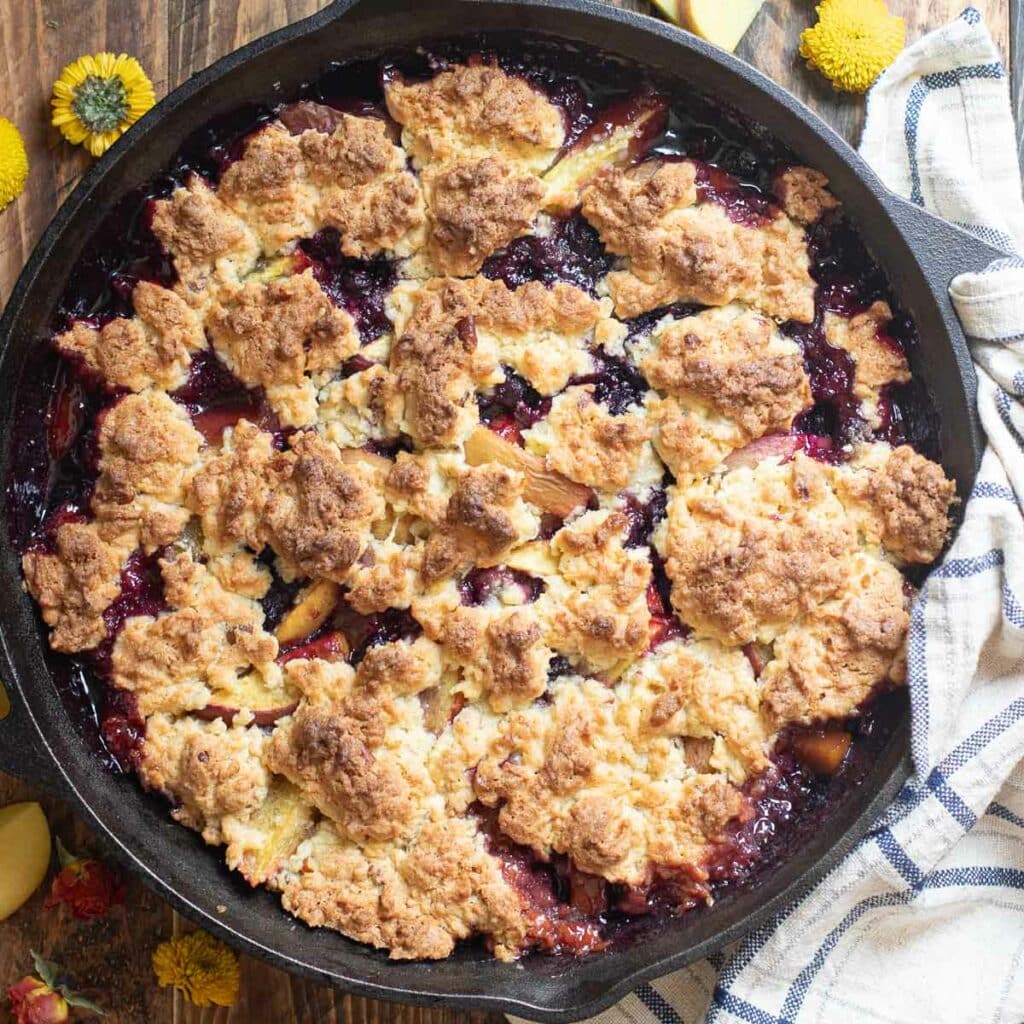 peach blueberry cobbler in a cast iron skillet