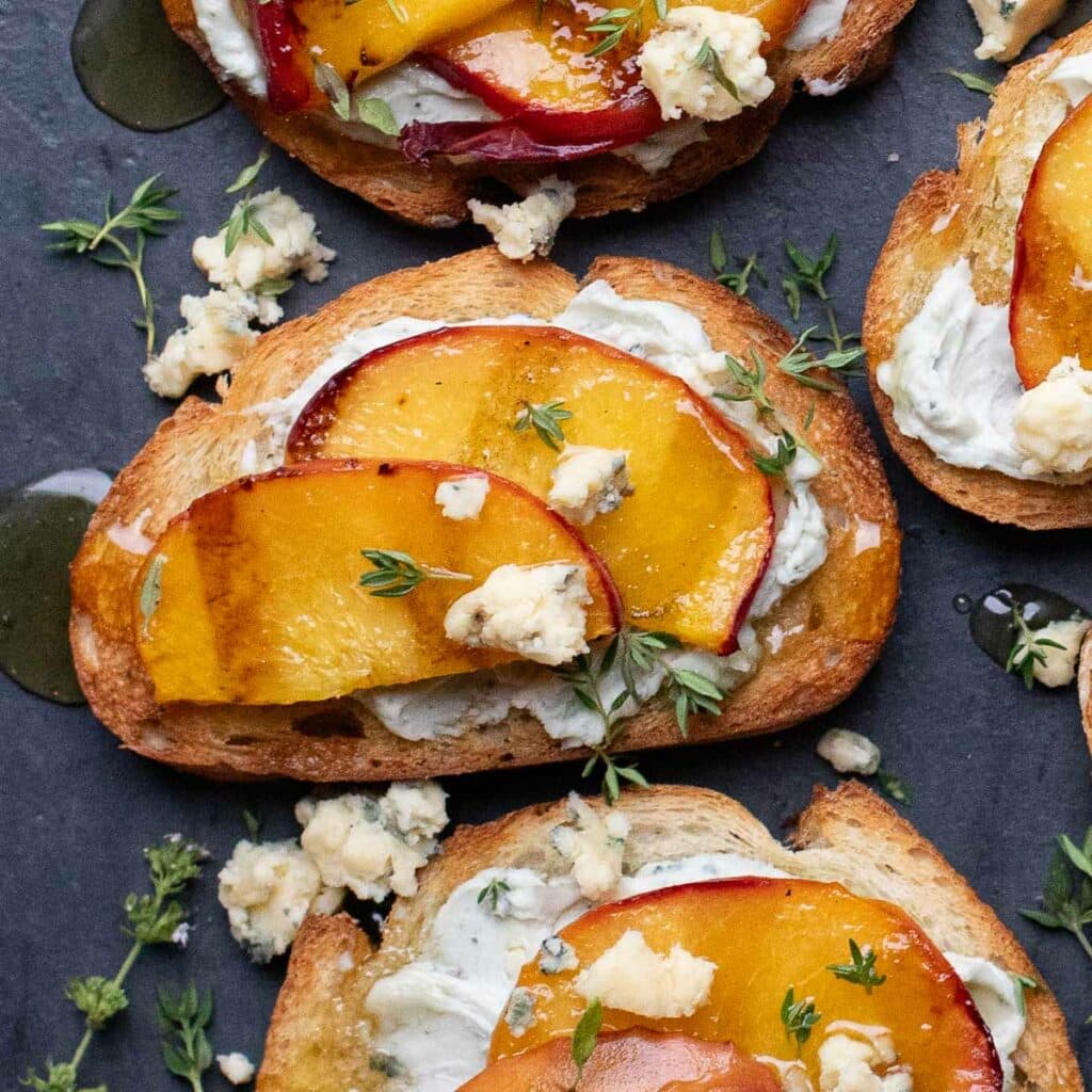 grilled peach bruschetta topped with blue cheese and fresh thyme