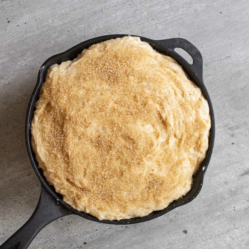 upside down cake batter in a cast iron pan before it is baked