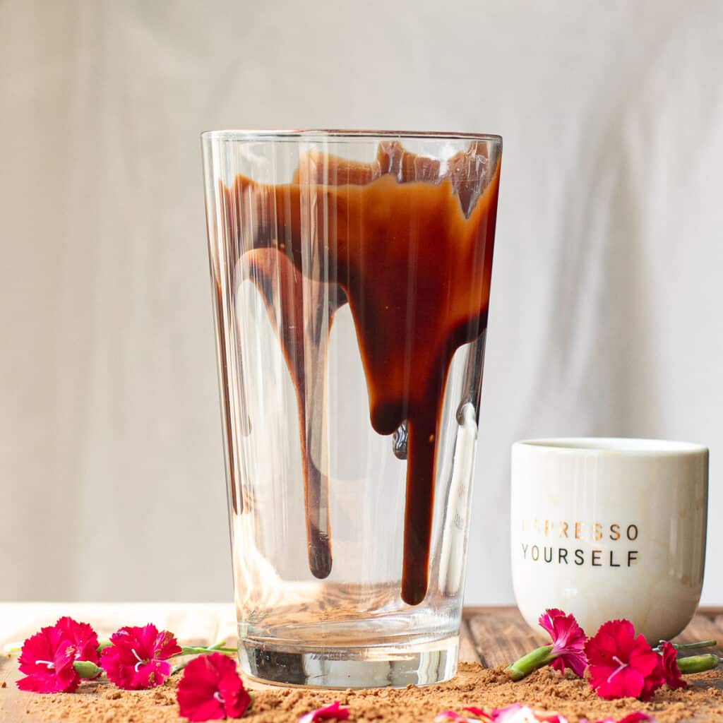 a tall glass drizzled with chocolate syrup