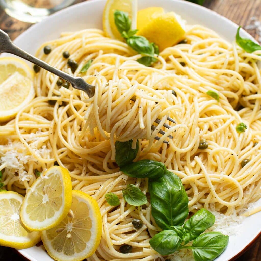 A fork twirling lemon caper pasta