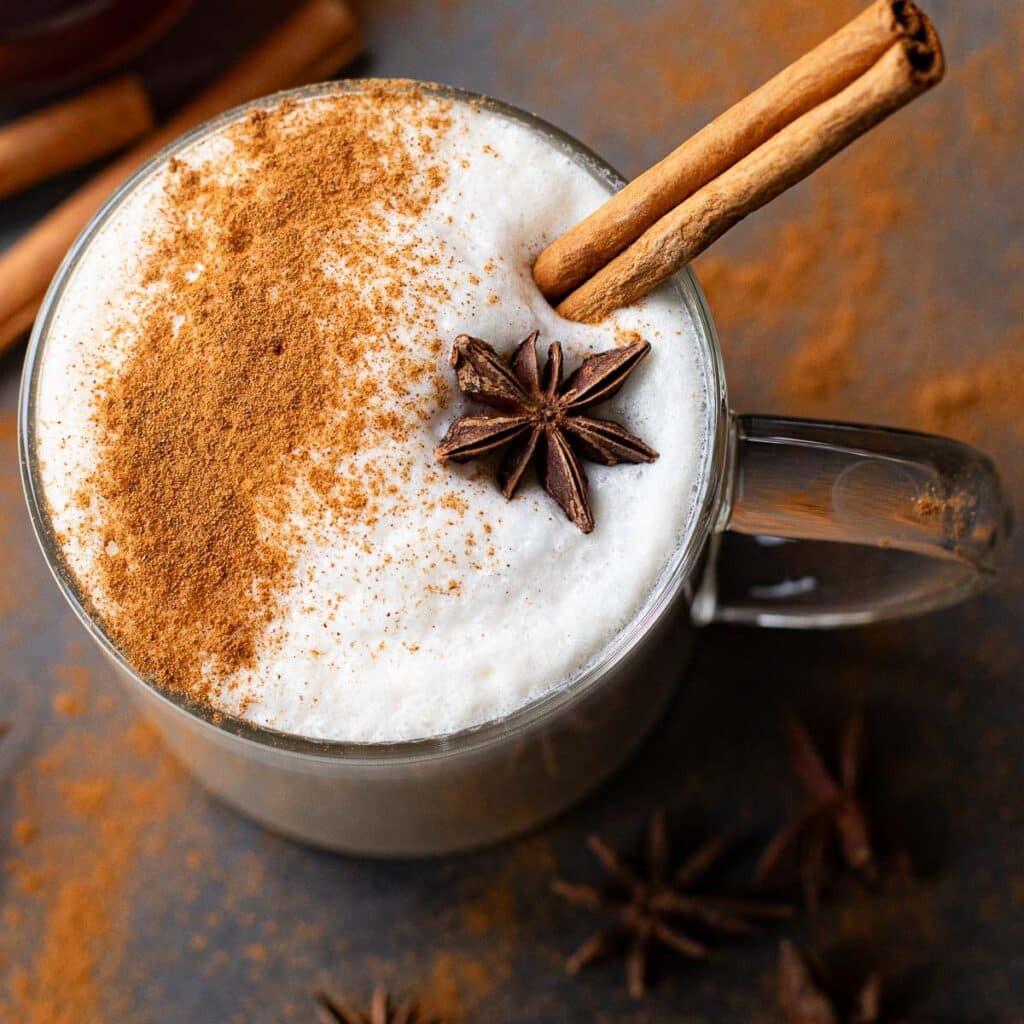 overhead view of a chai latte with a cinnamon stick and star anise