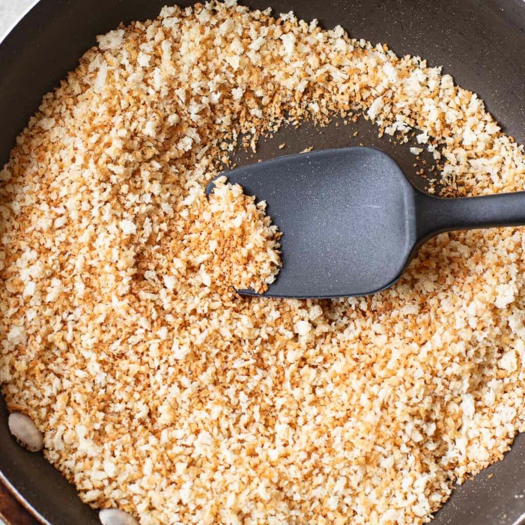 panko breadcrumbs being toasted in a pan