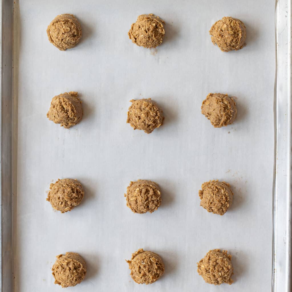 balls of oatmeal cookie dough on a baking sheet