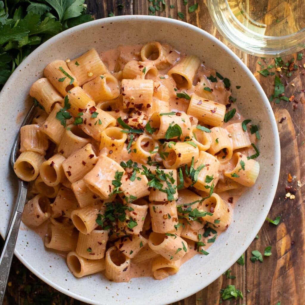 pasta with blush sauce in a cream colored bowl