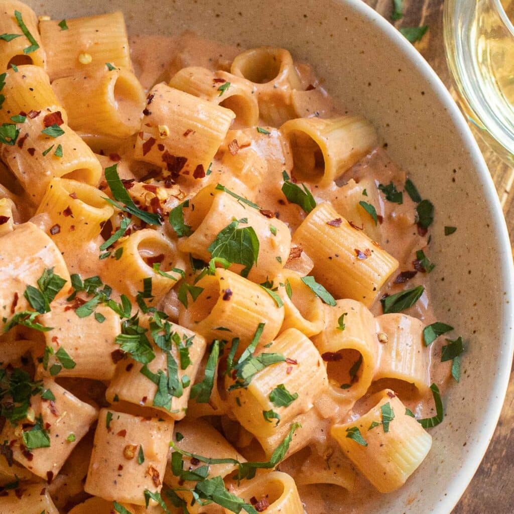 pasta with creamy blush sauce topped with fresh parsley