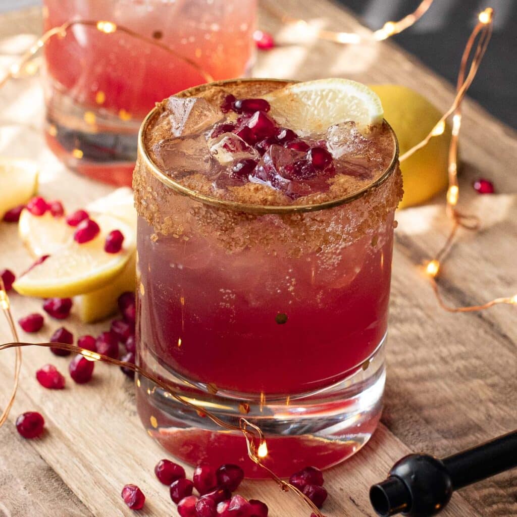 pomegranate gin fizz on a wooden board