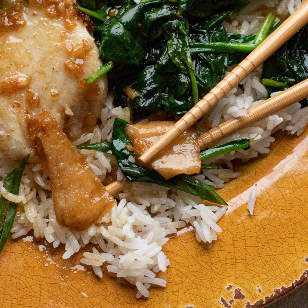 Asian tilapia with chopsticks and spinach