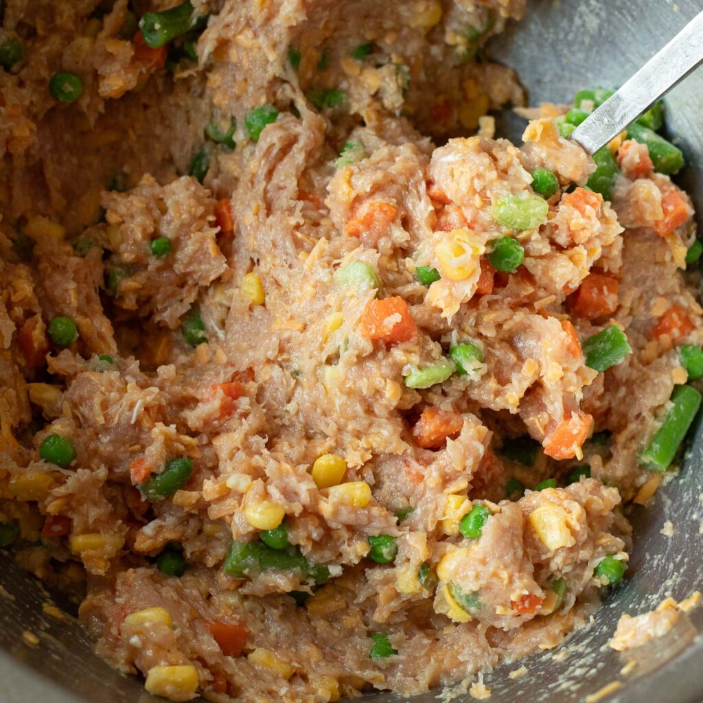 ground chicken and mixed vegetables in a mixing bowl