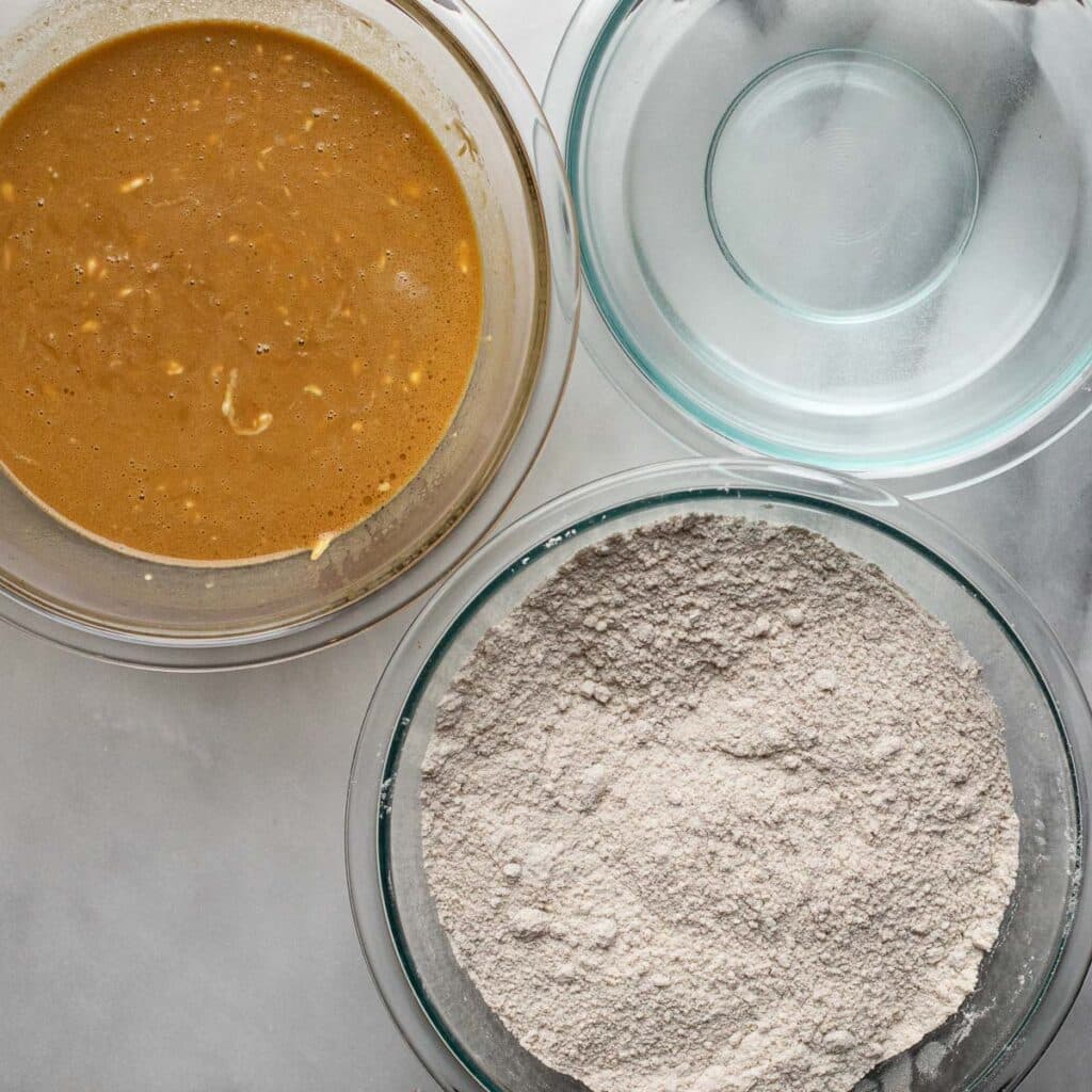 wet ingredients and dry ingredients for gingerbread in glass bowls
