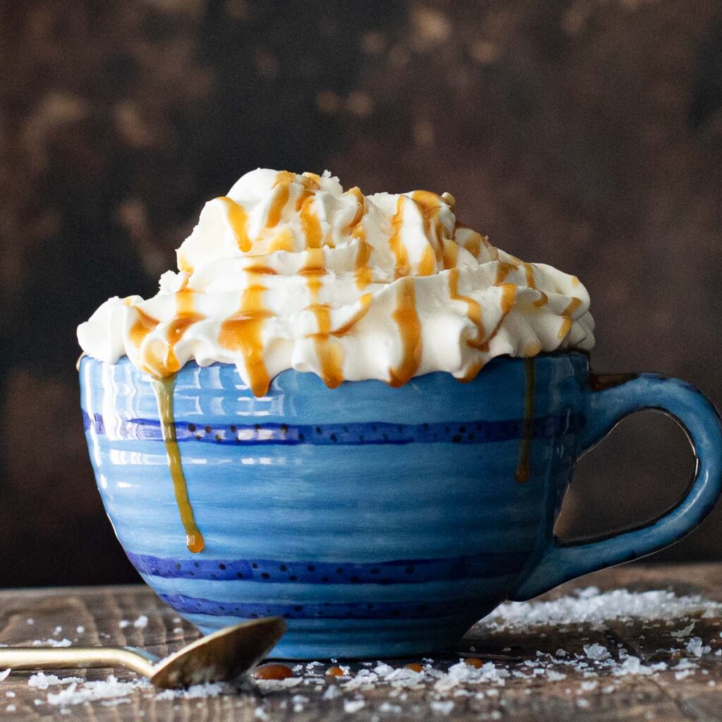 hot coffee topped with whipped cream and salted caramel