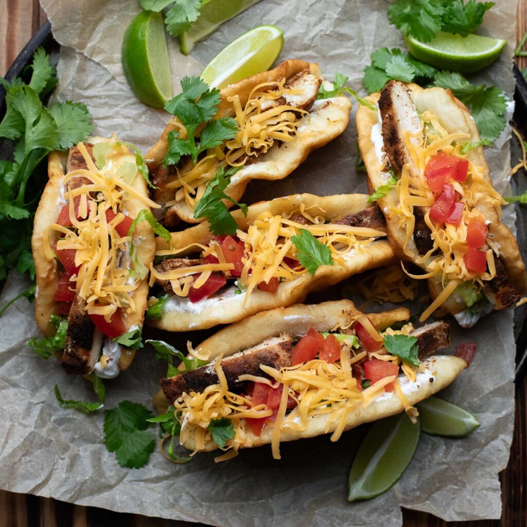 taco bell chicken chalupas topped with lettuce, tomatoes and cheese