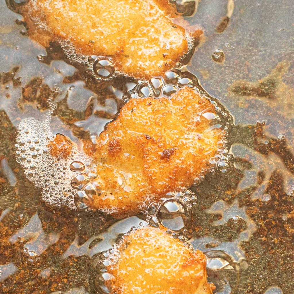 pickle slices frying in oil