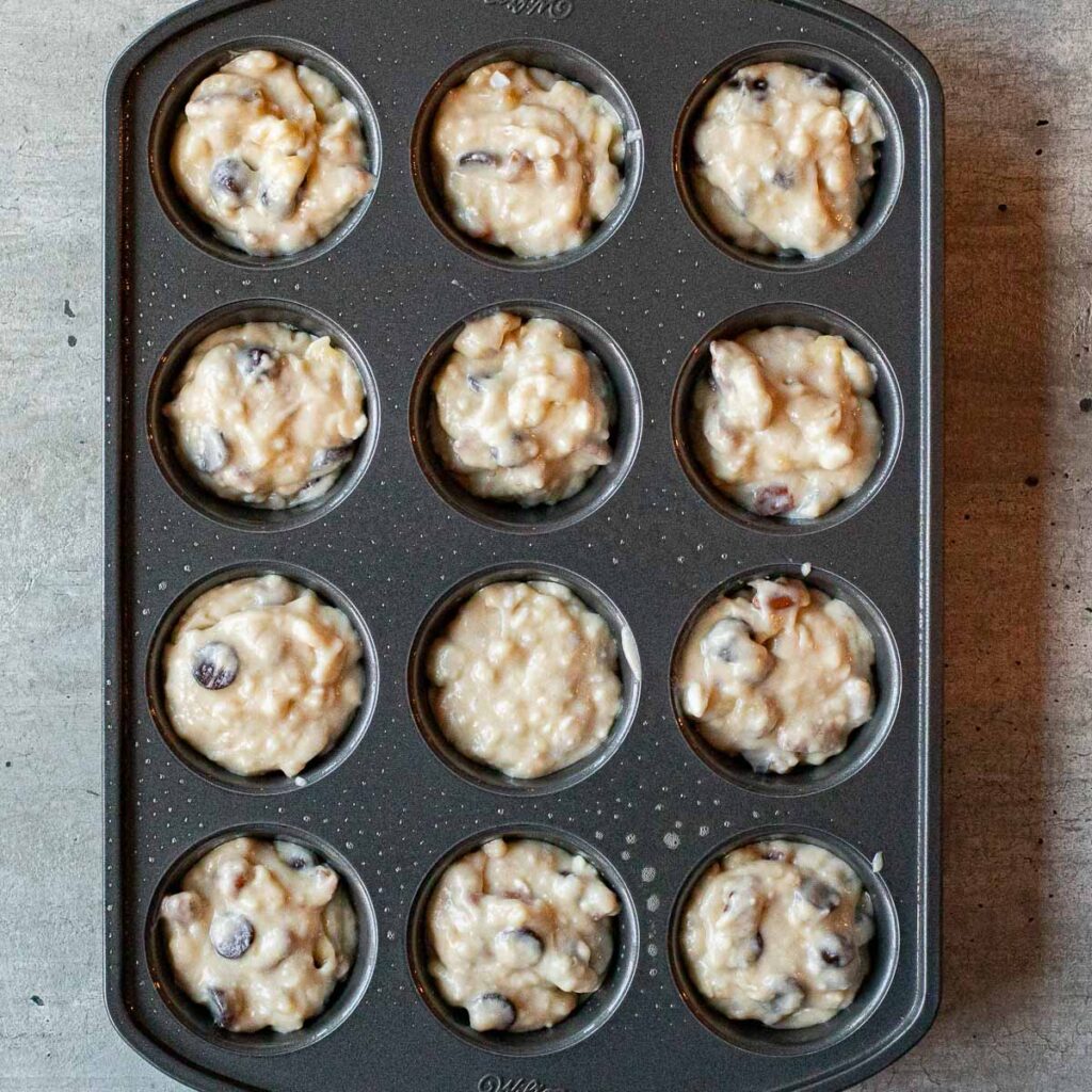 banana muffin batter in a muffin pan before it is baked