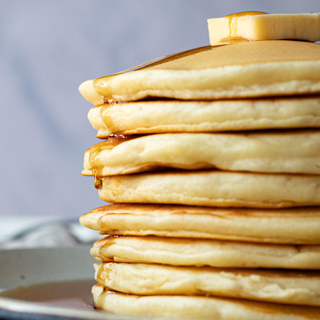 a stack of McDonald's pancakes with syrup dripping down the sides