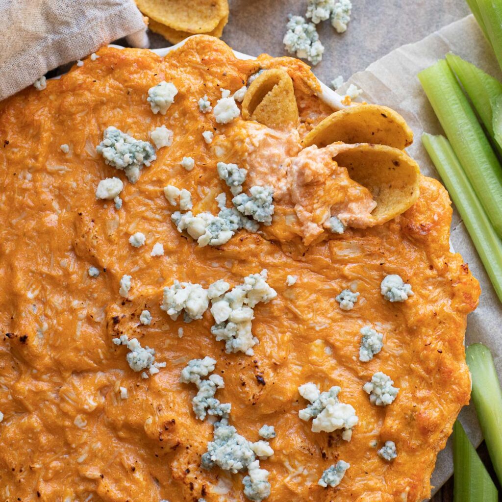buffalo chicken dip garnished with blue cheese crumbles