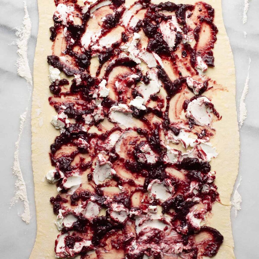 puff pastry sheet spread with goat cheese and blackberry jam