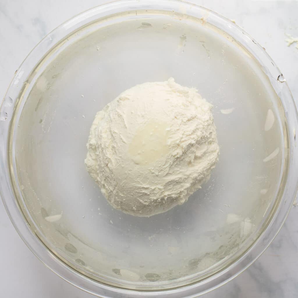 a ball of homemade mozzarella in an ice bath