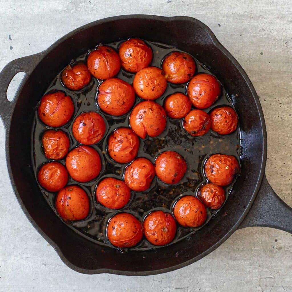 roasted cherry tomatoes in a cast iron skillet