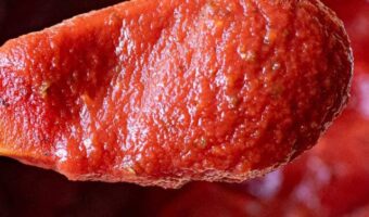 homemade pizza sauce on a wooden spoon