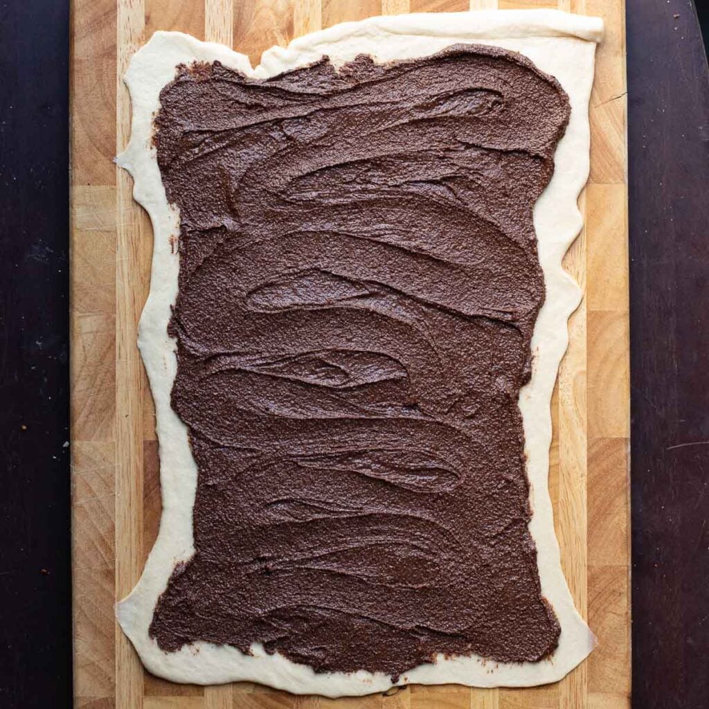 chocolate spread on top of a sheet of babka dough