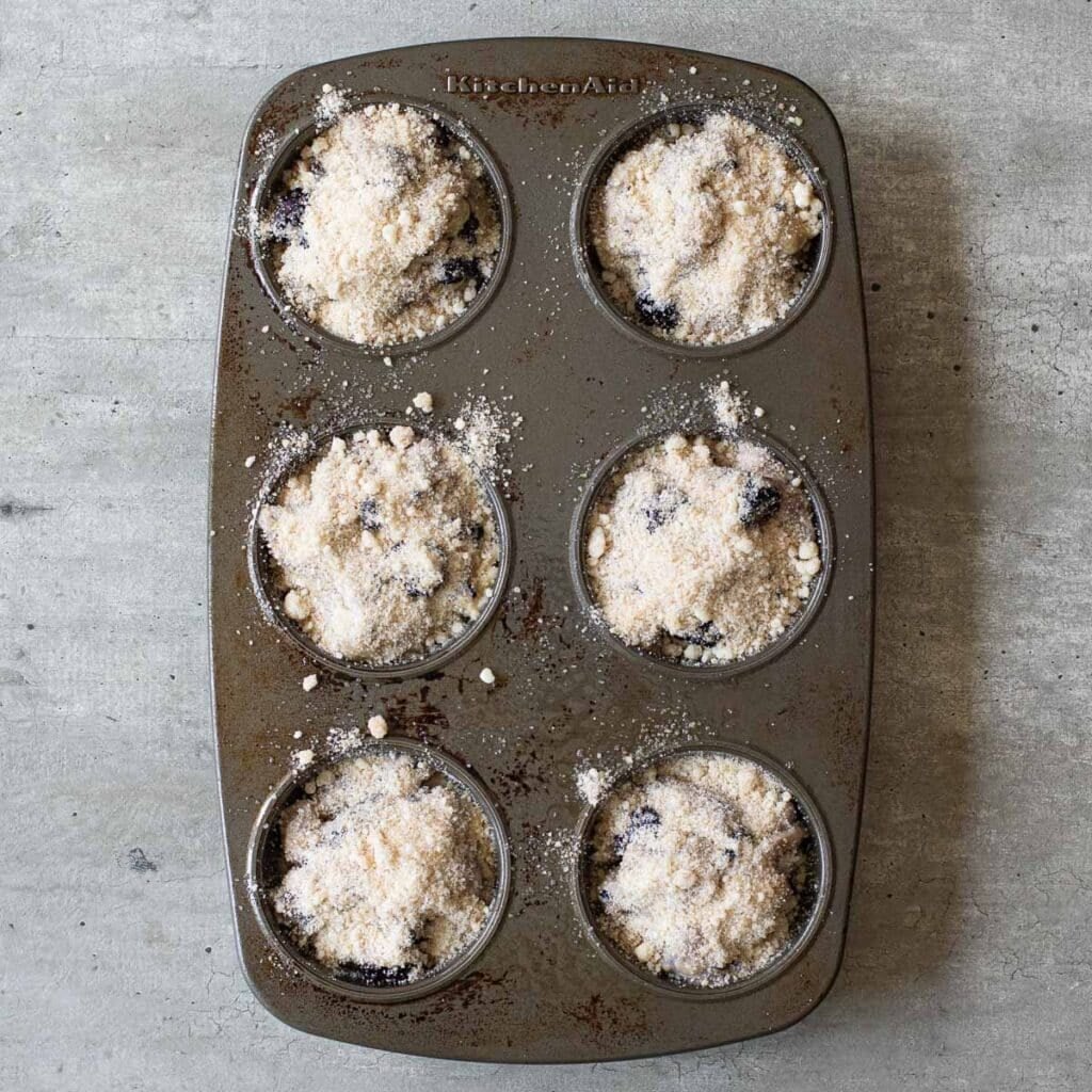 blackberry muffins in a muffin pan before baking