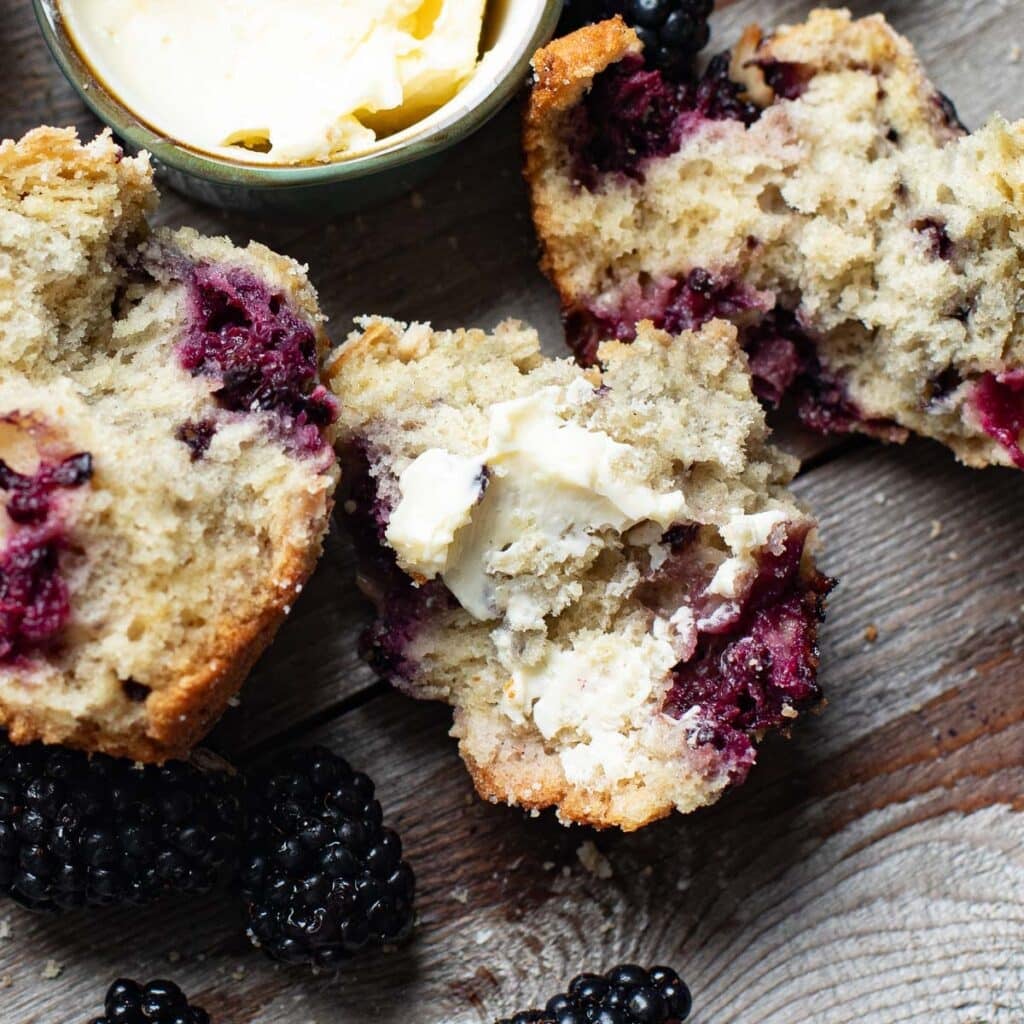 inside view of a gluten free blackberry muffin smeared with butter
