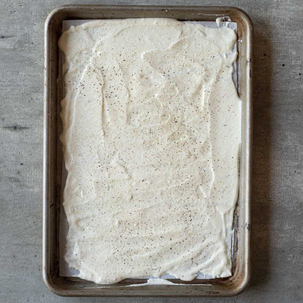 Cottage cheese wrap batter spread onto a baking sheet