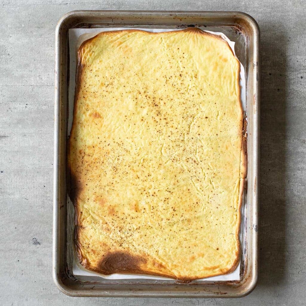 A cottage cheese wrapped after baking on a rectangular baking sheet