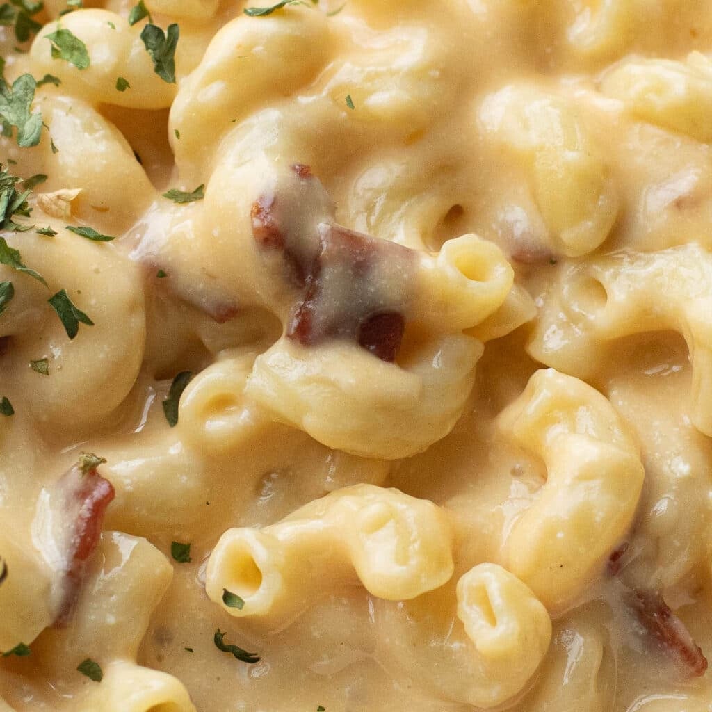 close up of smoky gouda mac and cheese with bacon