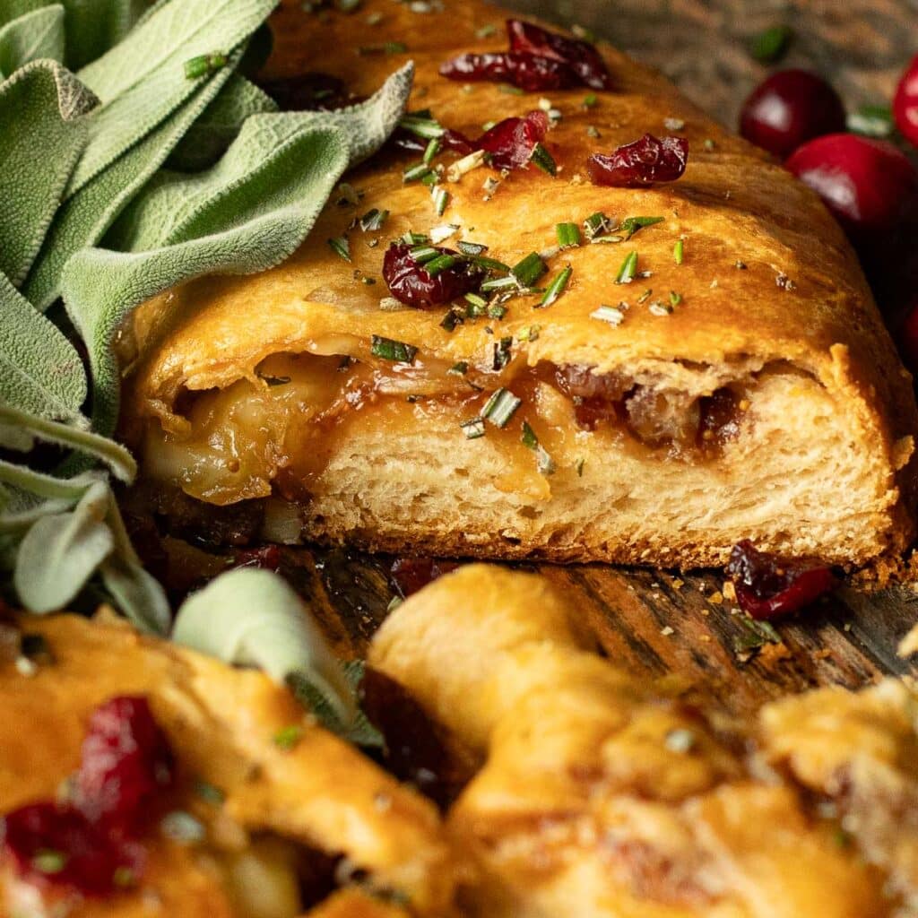 inside a slice of crescent roll filled with brie and fig jam