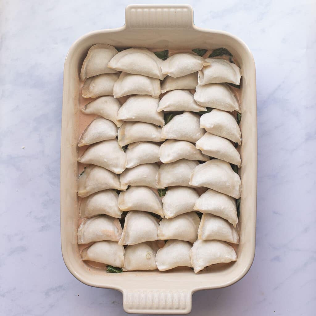 frozen dumplings arranged in a baking dish