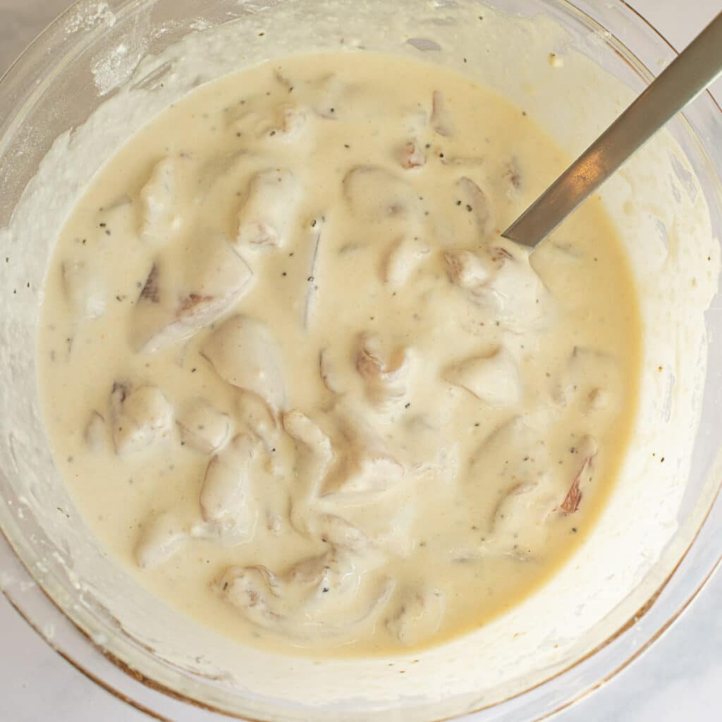 chicken pieces marinating in batter