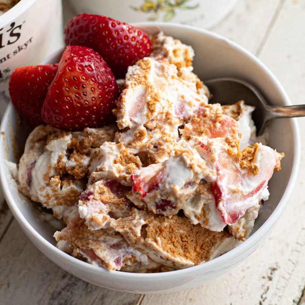 viral Japanese cheesecake with strawberries in a white bowl