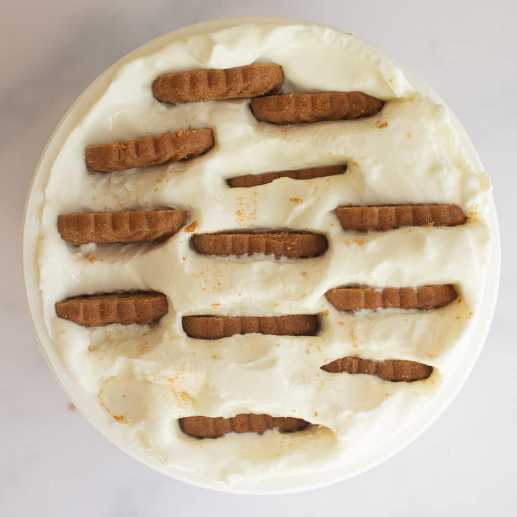 overhead view of a container of yogurt with Biscoff cookies inserted into it 