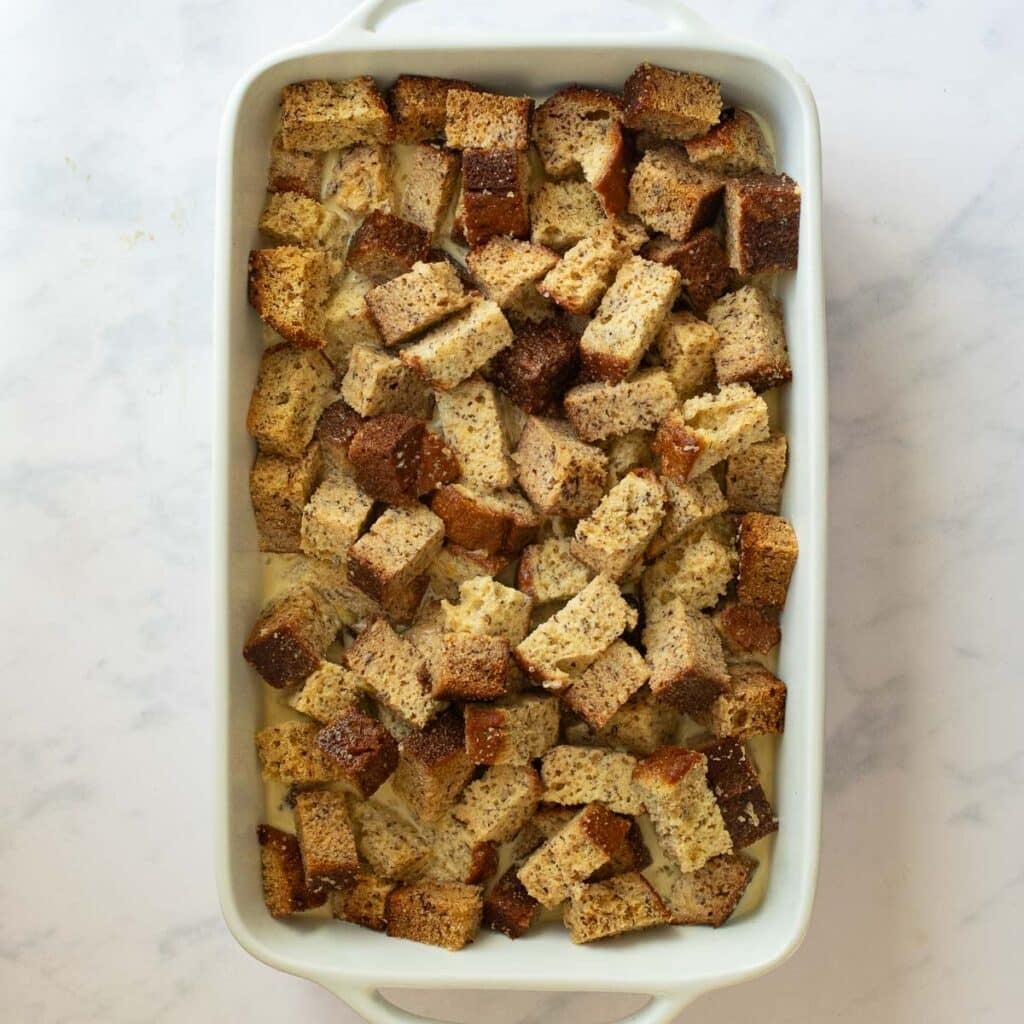 cubed banana bread in a 9x13 baking dish
