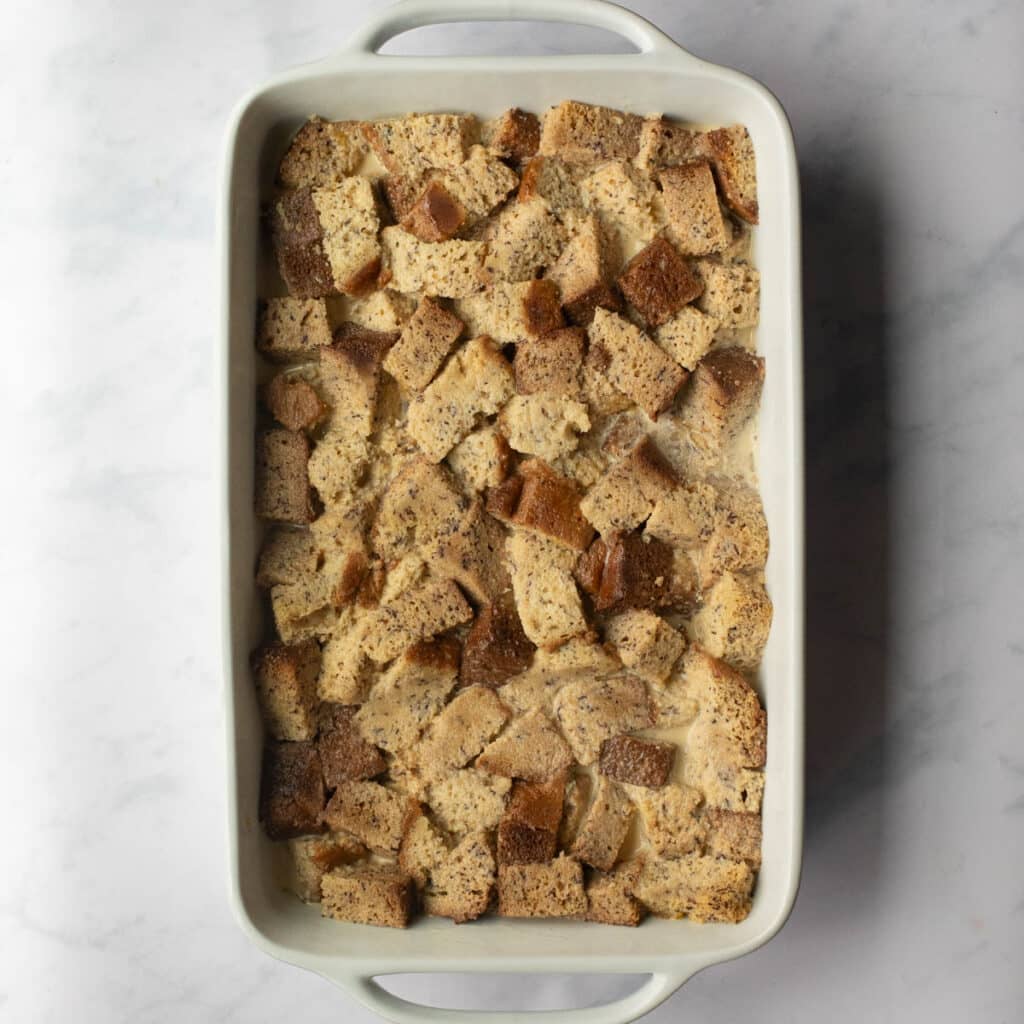 banana bread bread pudding in a casserole dish before it is baked