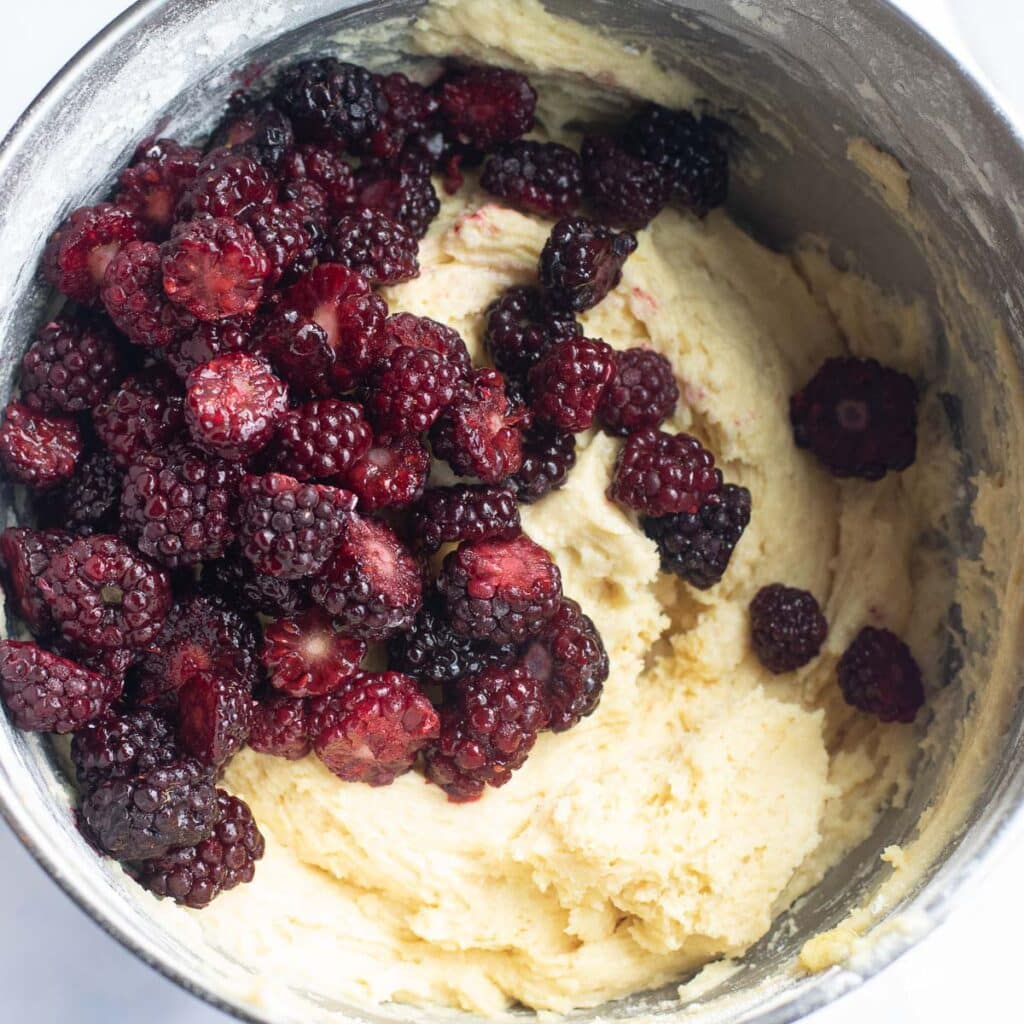 blackberries and cake batter in a mixing bowl