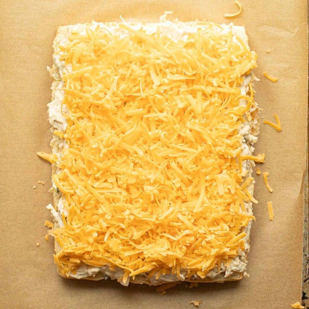 chicken and cheddar cheese spread over the bottom half of slider buns