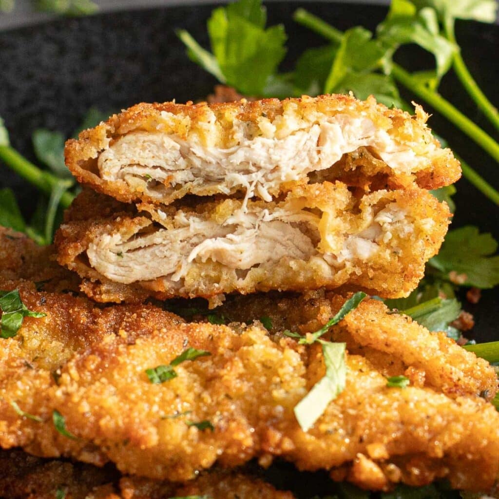 chicken cutlet cut in half so the inside is visible