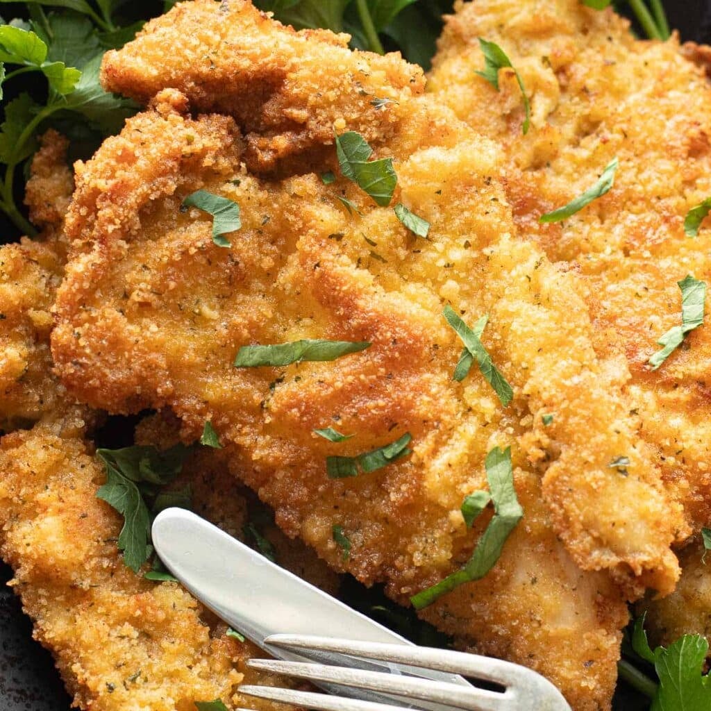 chicken cutlet topped with chopped parsley