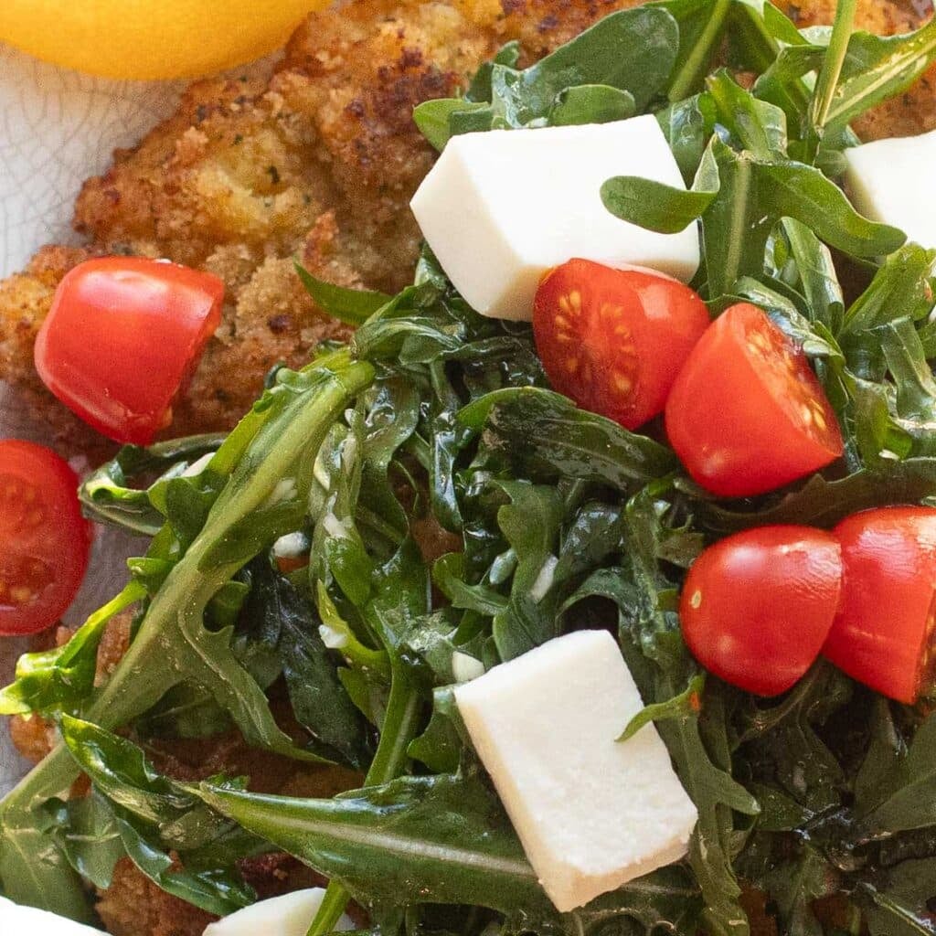 arugula salad with grape tomatoes and fresh mozzarella cheese