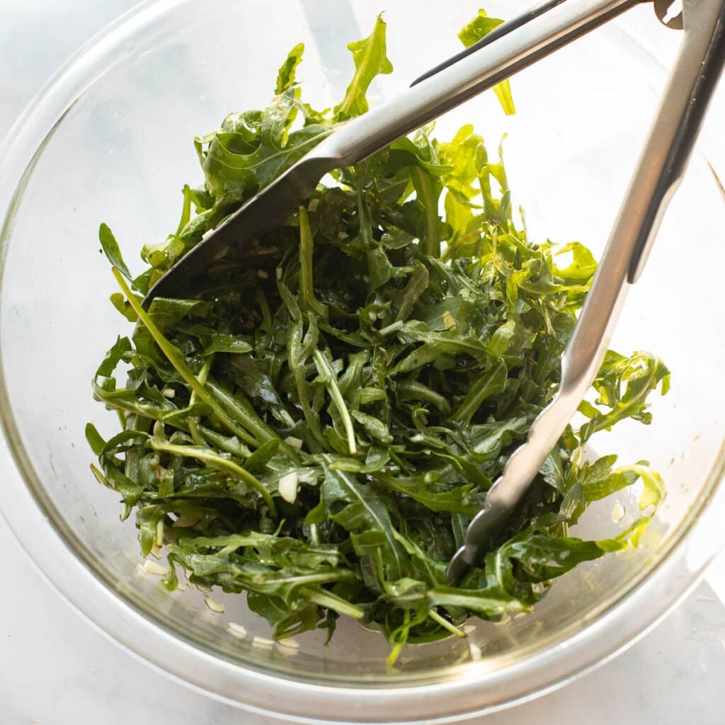 arugula salad in a mixing bowl