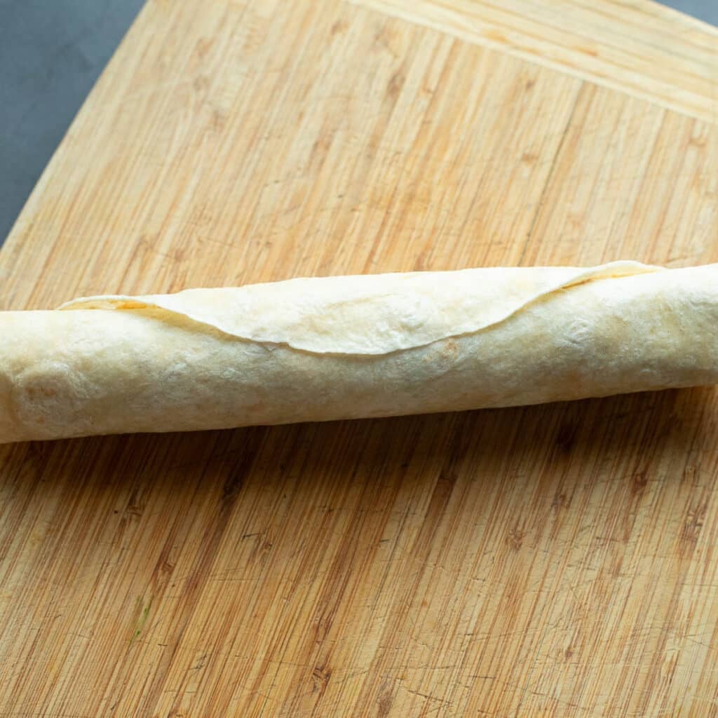 rolled tortilla on a wooden board