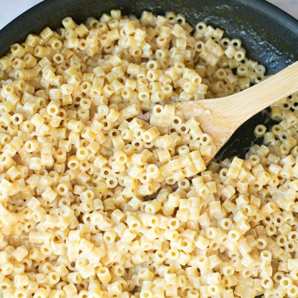 ditalini pasta with butter and cream in a pan