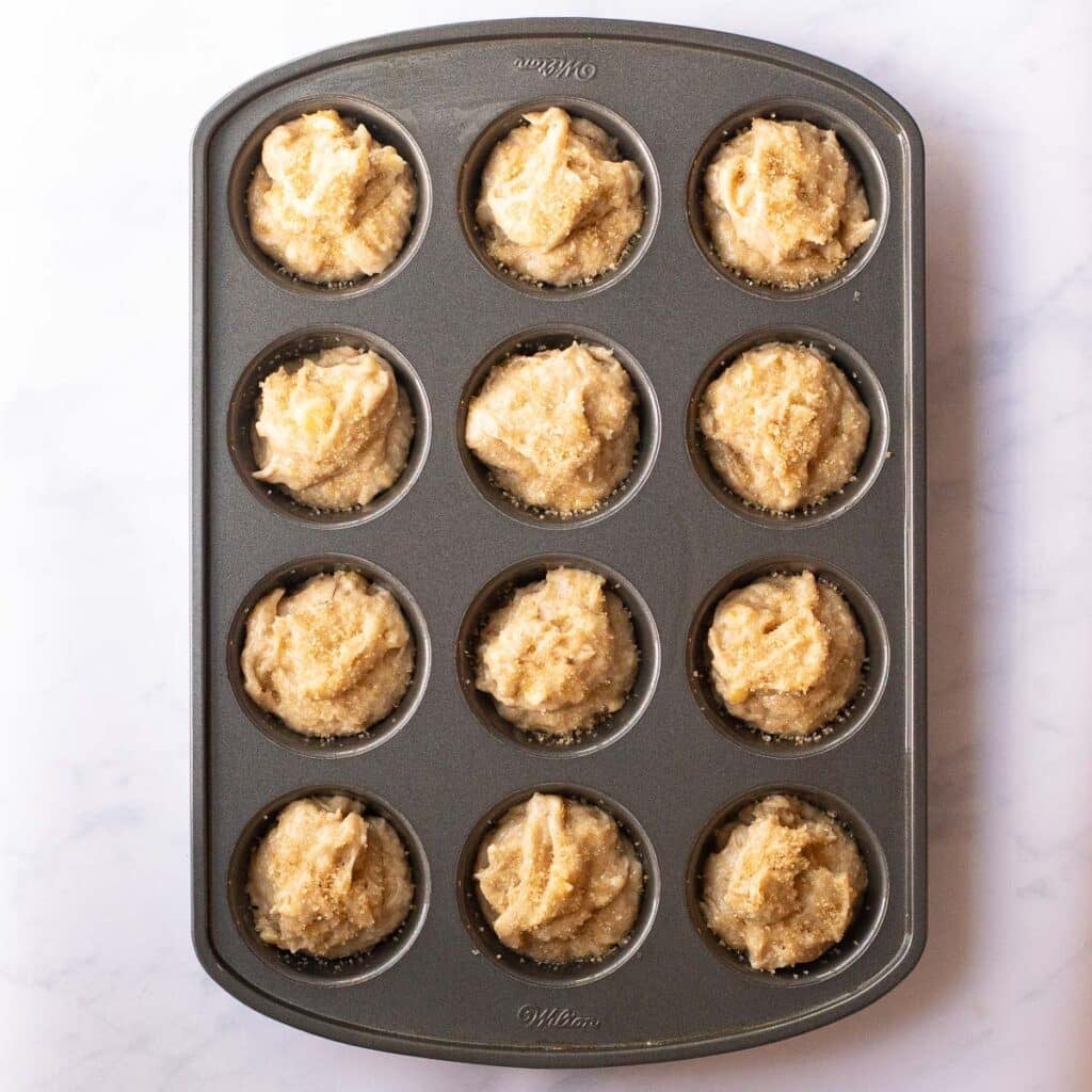 gluten free banana bread muffin batter in a muffin pan before baking