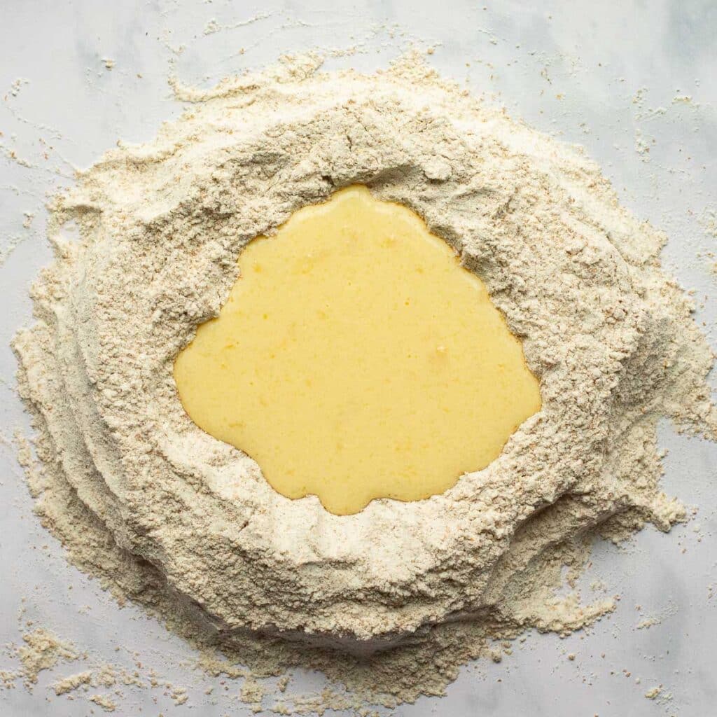 a well of flour with buttermilk in the center