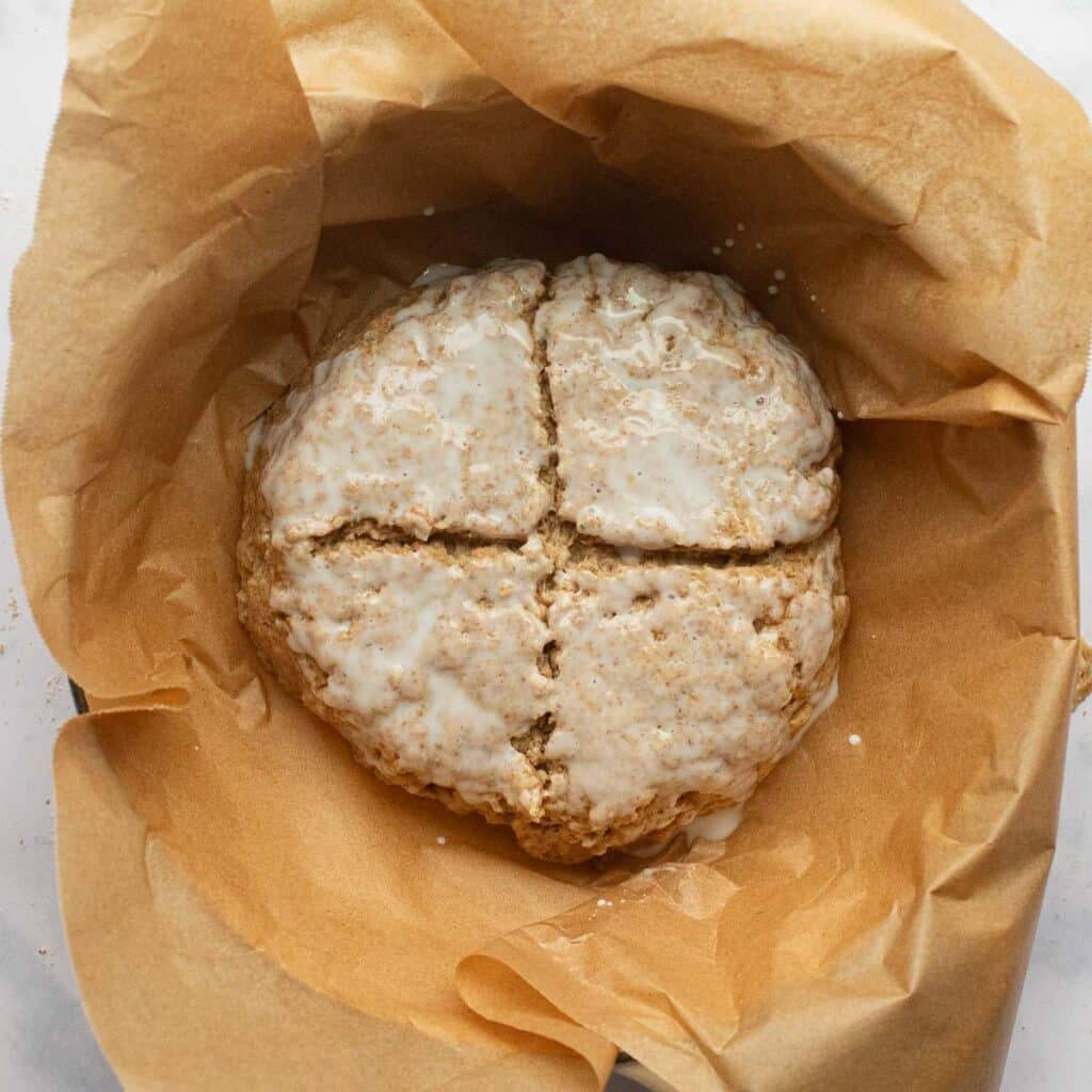 Irish brown soda bread scored with a deep cross before baking