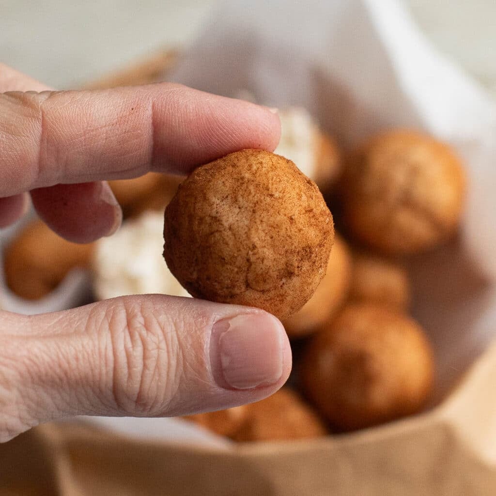a hand holding one Irish potato candy