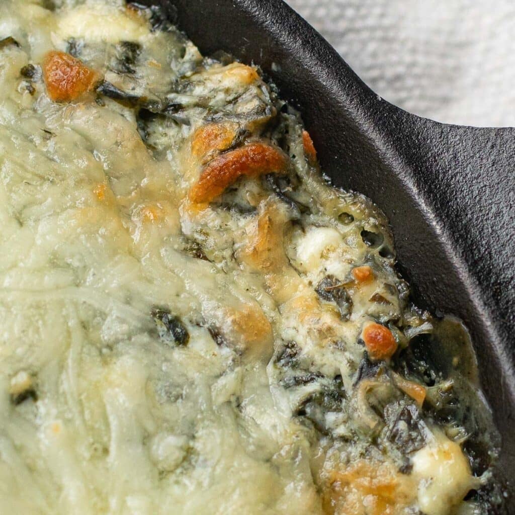 close up view of baked spinach dip